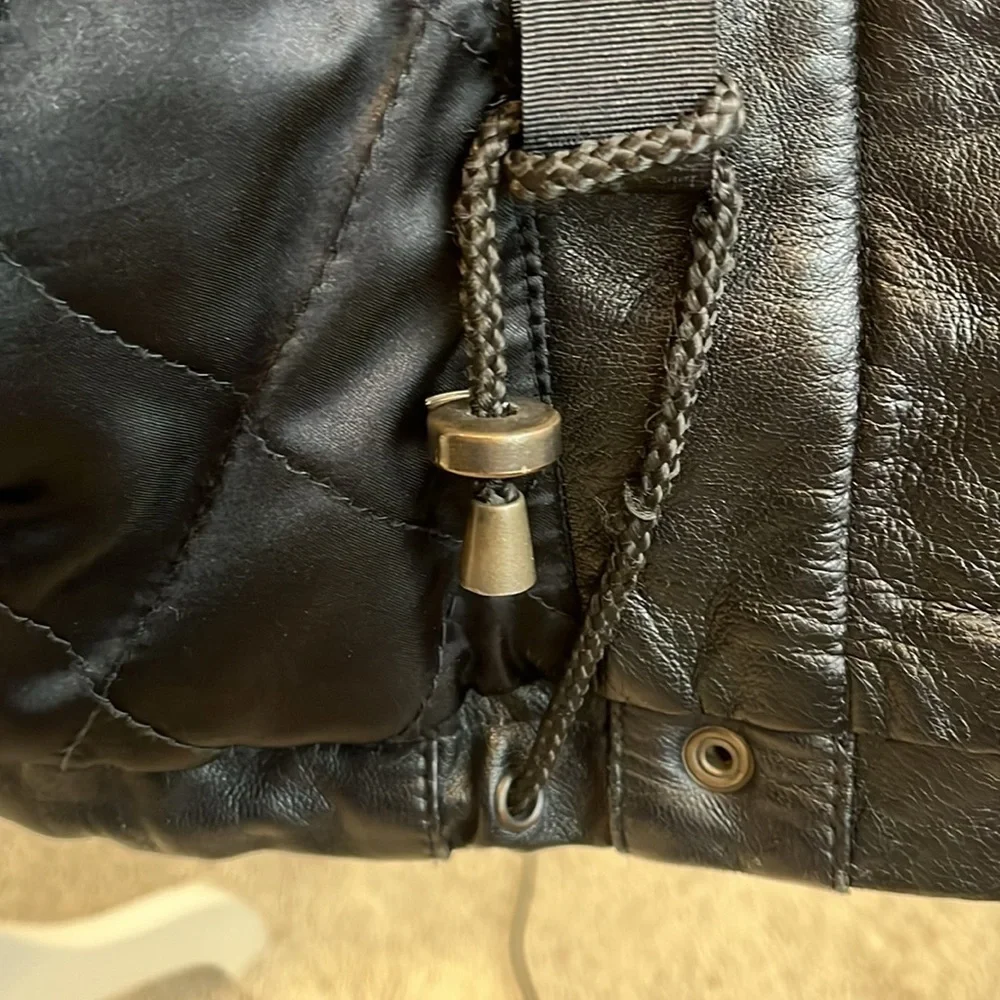 Vintage men’s SZ sm black leather coat w/fur trim hood.  Hits below the hips.